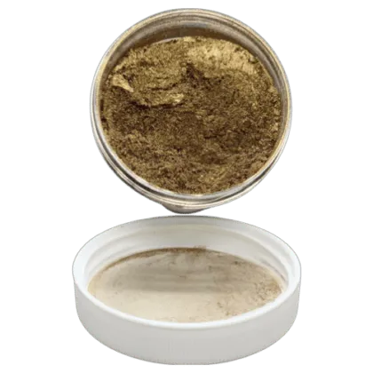 Bronzer pearl in jar spilling onto the lid in front of it