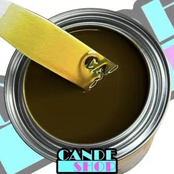 unreduced Pineapple Cande in a quart can with a stainless steel mixing stick being pulled out to show the yellow gold transparent color