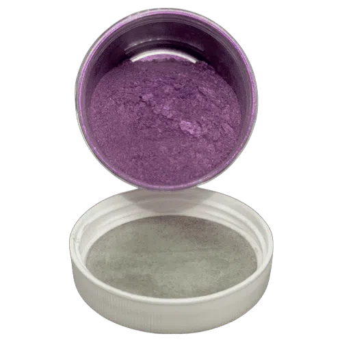 Prometh Purp Pearl in a jar spilling onto a white lid underneath it